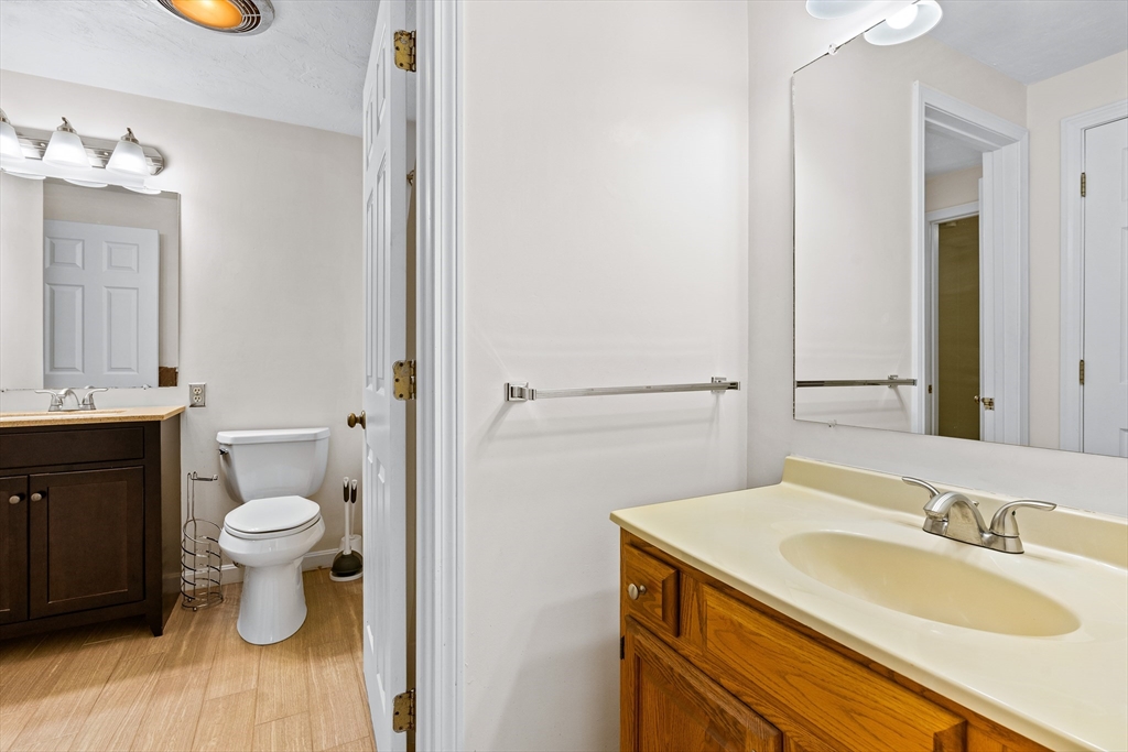 303 Ridgefield Circle, Unit B Clinton, MA 01510 - Photo 12 of 23 a bathroom with a sink a toilet and mirror