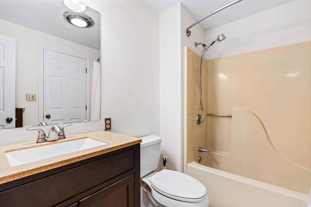 303 Ridgefield Circle, Unit B Clinton, MA 01510 - Photo 13 of 23 a bathroom with a sink a toilet a mirror and shower