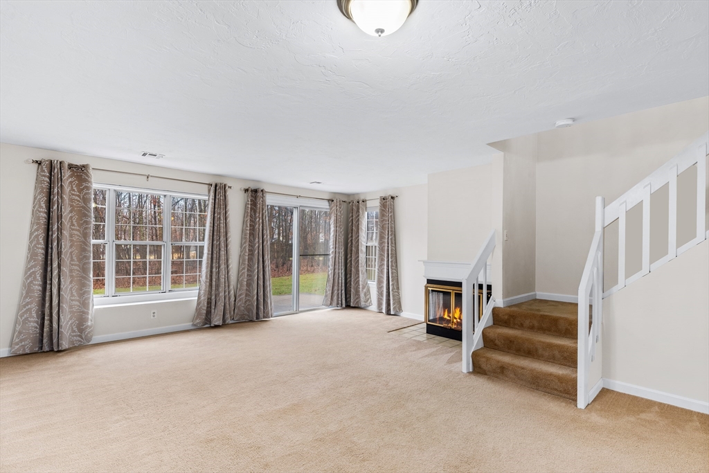 303 Ridgefield Circle, Unit B Clinton, MA 01510 - Photo 6 of 23 a living room with furniture and a fireplace