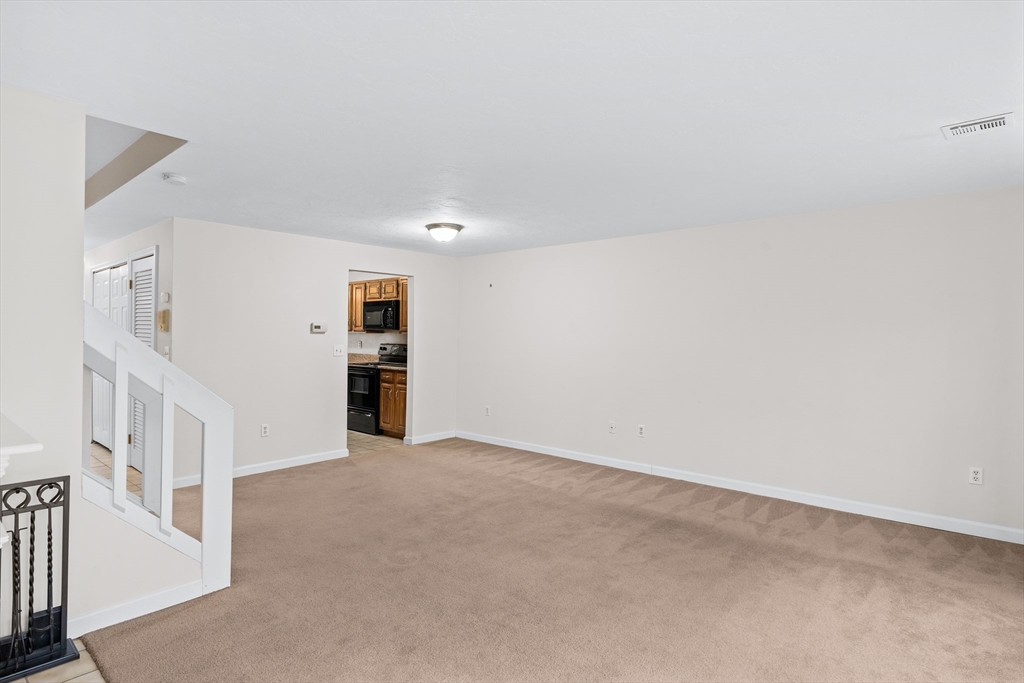 303 Ridgefield Circle, Unit B Clinton, MA 01510 - Photo 7 of 23 a view of an empty room with a window