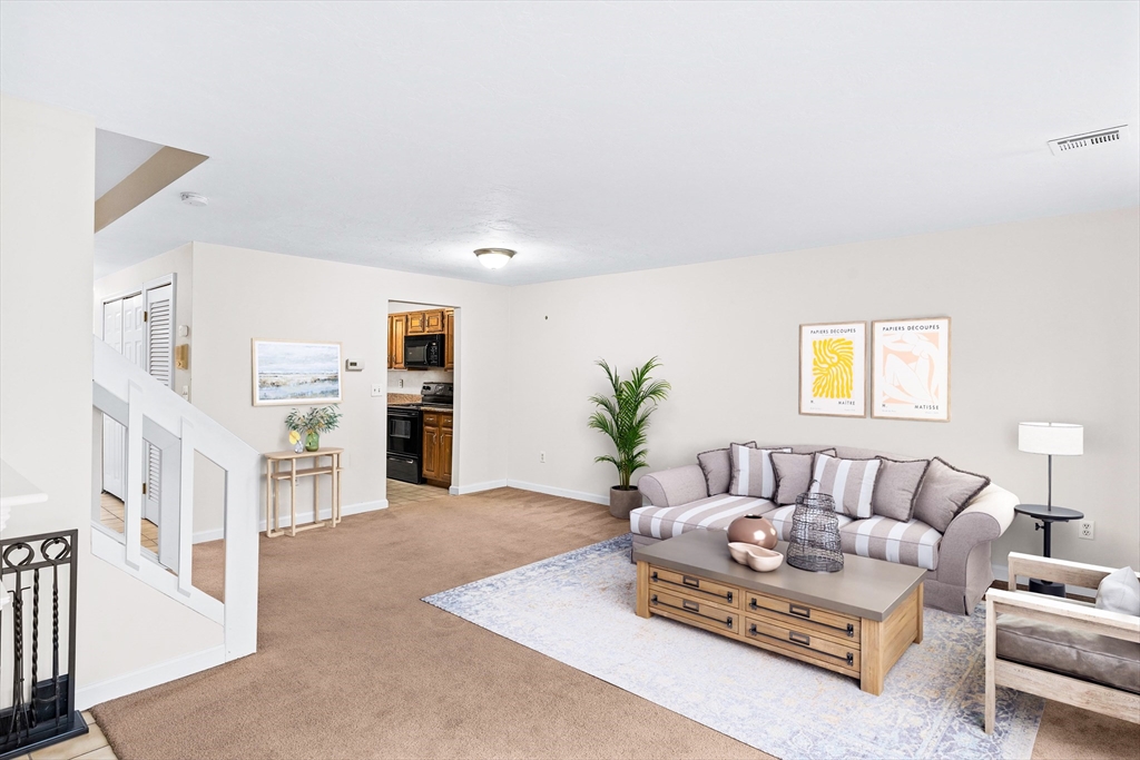 303 Ridgefield Circle, Unit B Clinton, MA 01510 - Photo 8 of 23 a living room with furniture and a couch