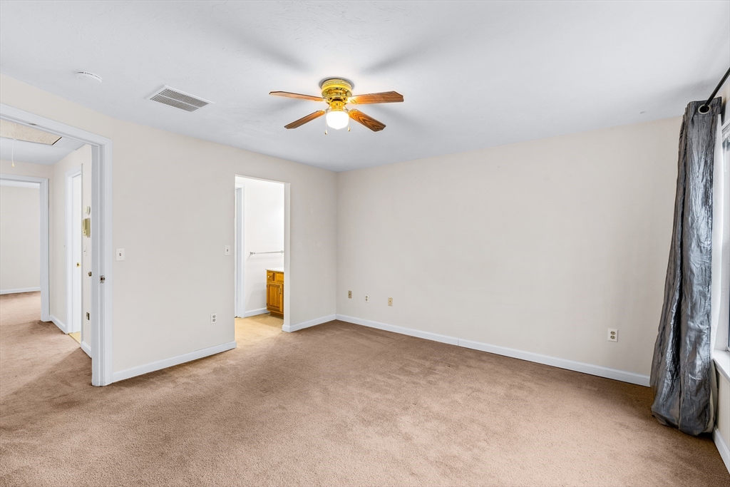 303 Ridgefield Circle, Unit B Clinton, MA 01510 - Photo 10 of 23 a view of a room with a fan and a window