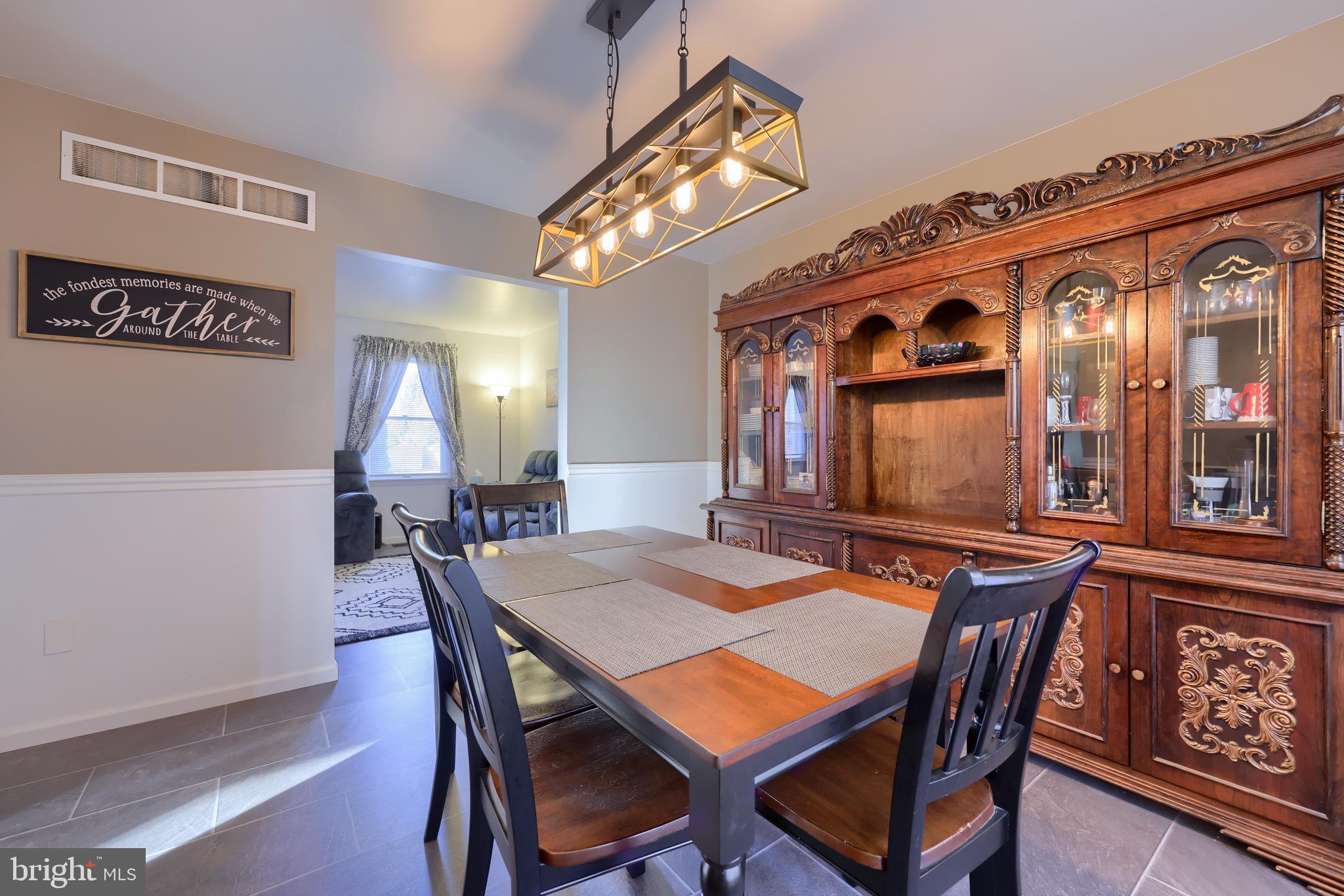 1022 Boeshore Circle Reading, PA 19605 - Photo 11 of 39 a dining room with furniture a rug and wooden floor