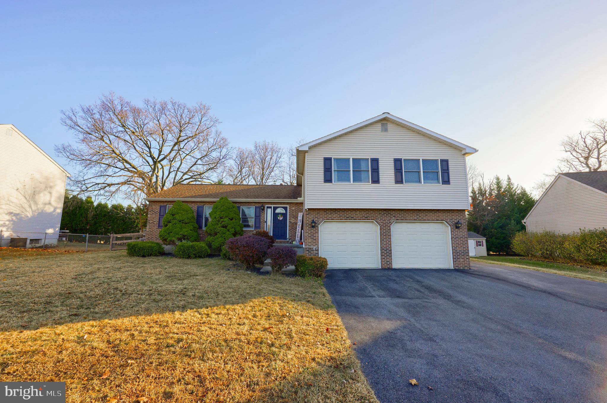 1022 Boeshore Circle Reading, PA 19605 - Photo 2 of 39 a front view of a house with a yard and garage