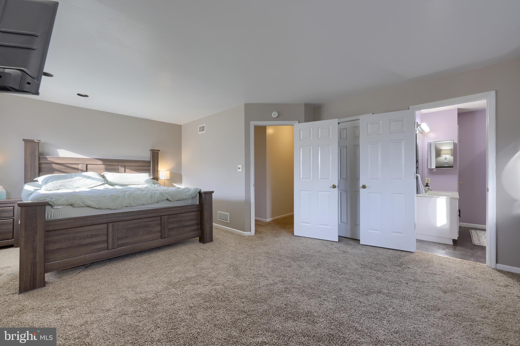 1022 Boeshore Circle Reading, PA 19605 - Photo 22 of 39 a spacious bedroom with a bed and a lamp