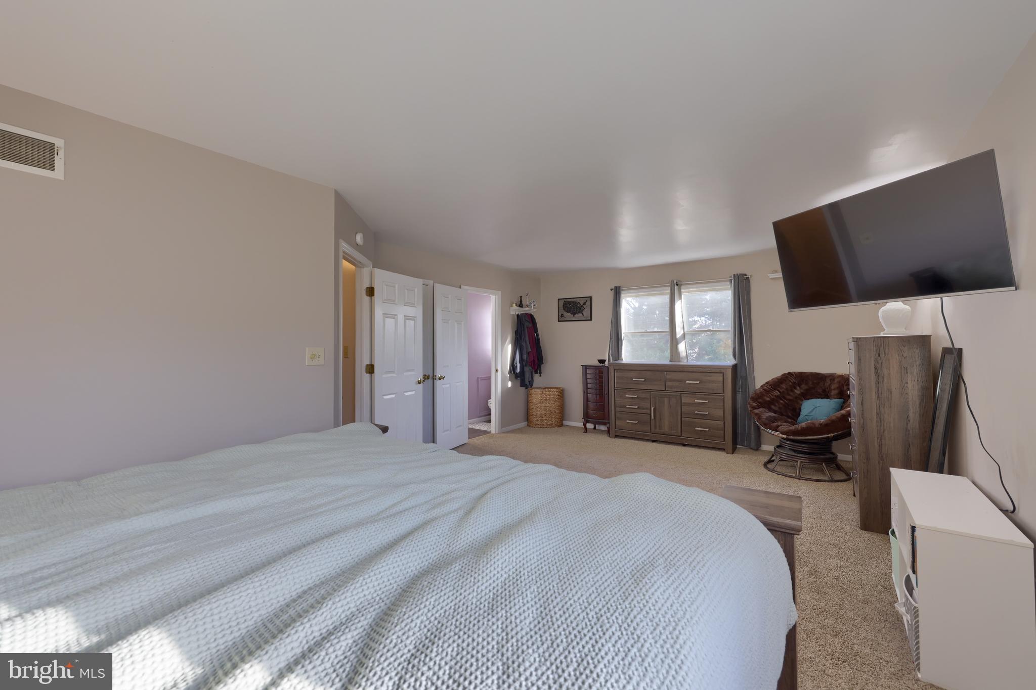 1022 Boeshore Circle Reading, PA 19605 - Photo 23 of 39 a bedroom with a bed and a flat tv screen on the dresser