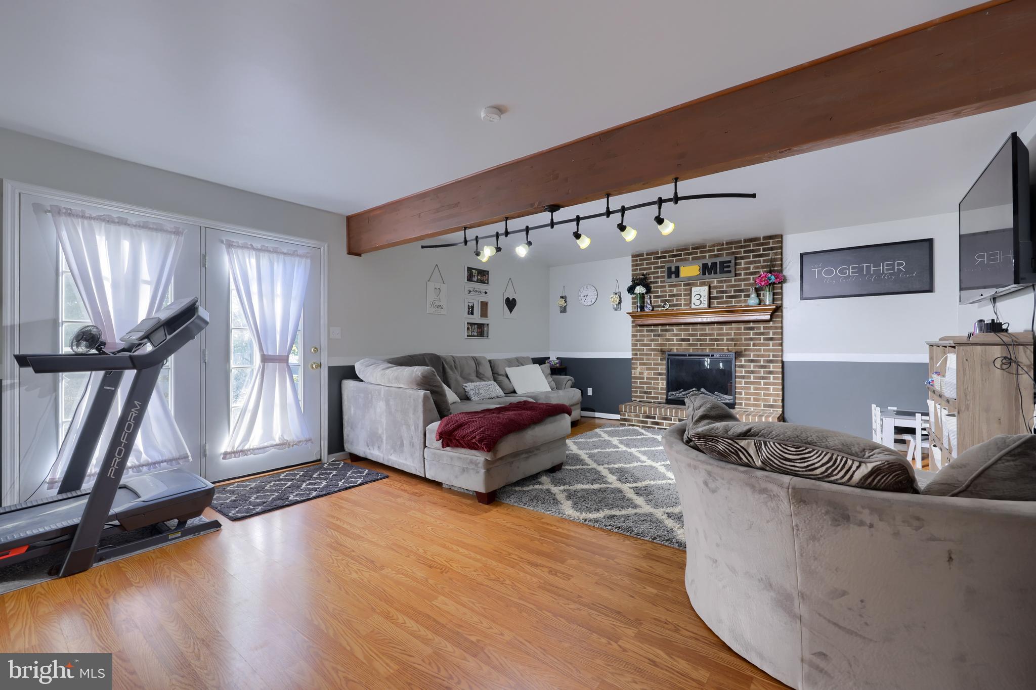 1022 Boeshore Circle Reading, PA 19605 - Photo 28 of 39 a living room with furniture gym equipment and a flat screen tv