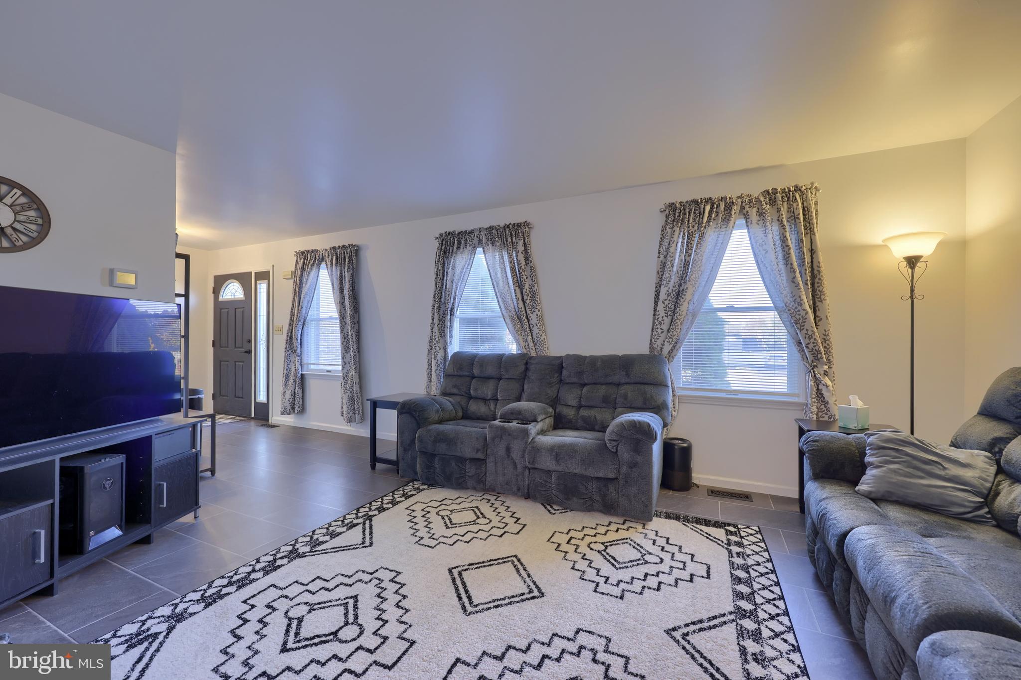 1022 Boeshore Circle Reading, PA 19605 - Photo 8 of 39 a living room with furniture and a flat screen tv