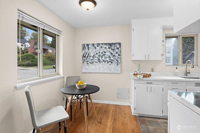 a view of a kitchen area with furniture and wooden floor