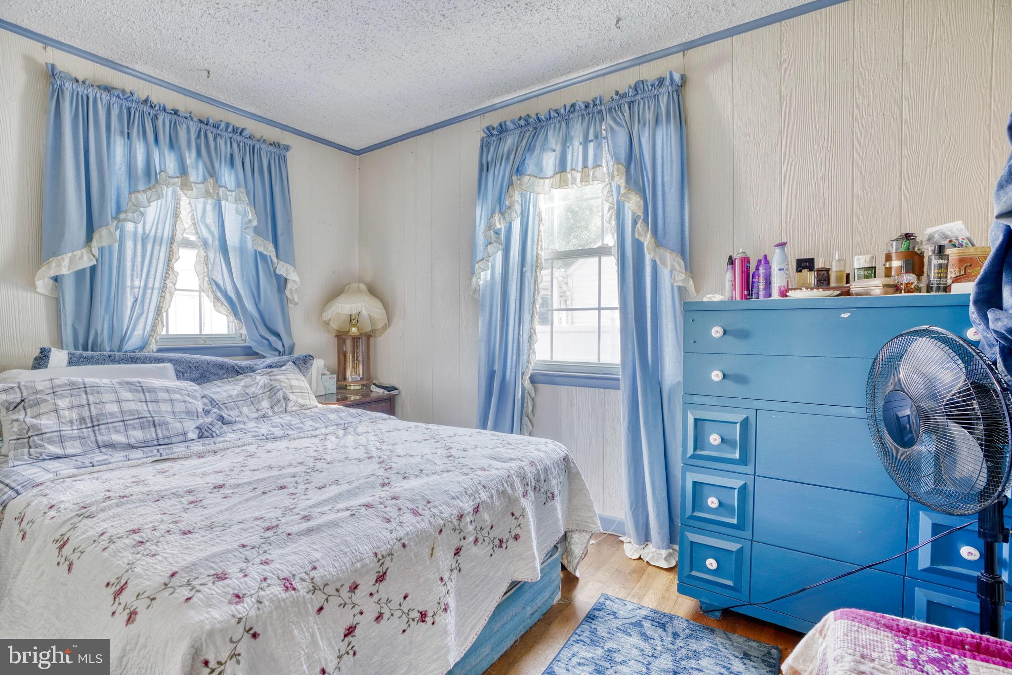 1903 Adams Road Baltimore, MD 21222 - Photo 17 of 29 a bedroom with a bed and large windows
