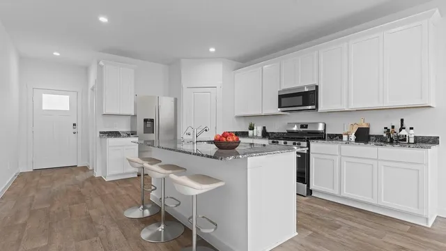 a kitchen with a sink cabinets and appliances