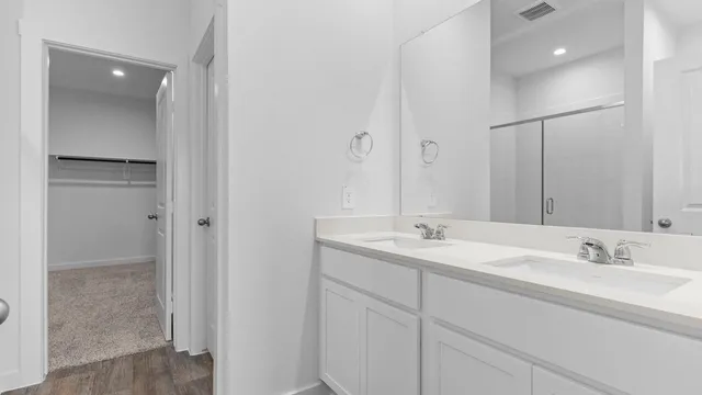 a bathroom with 2 sink and a mirror