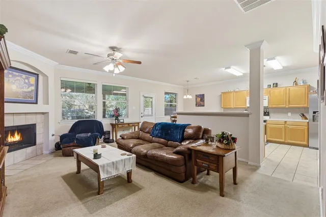a living room with furniture a fireplace and a flat screen tv