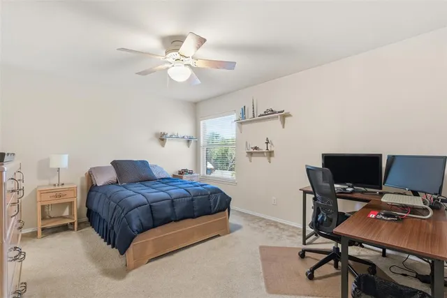 a bedroom with a bed and a desk