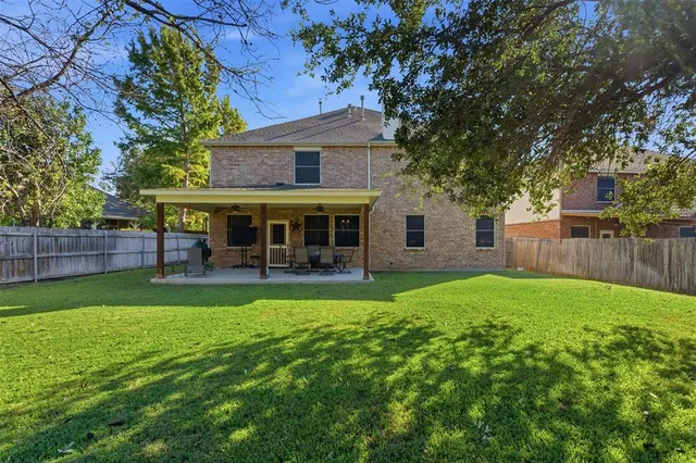 a view of a house with a yard and sitting area