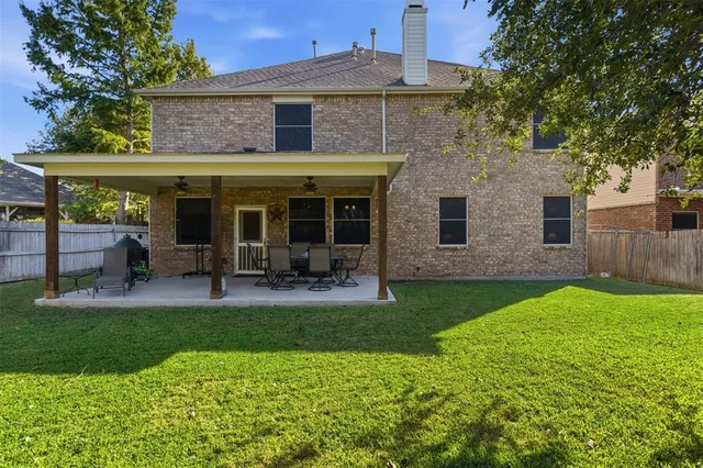 a view of a house with backyard porch and sitting area