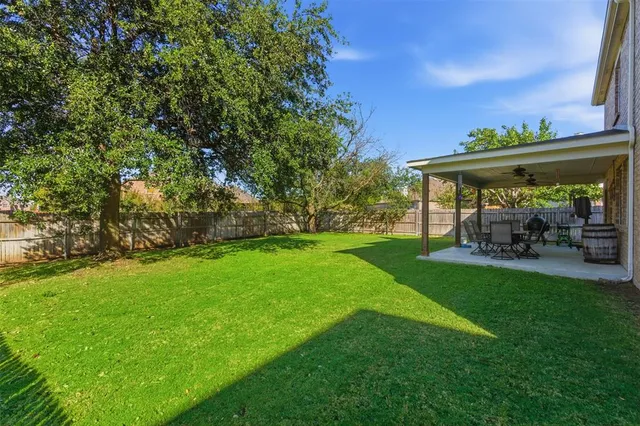 a view of yard with patio