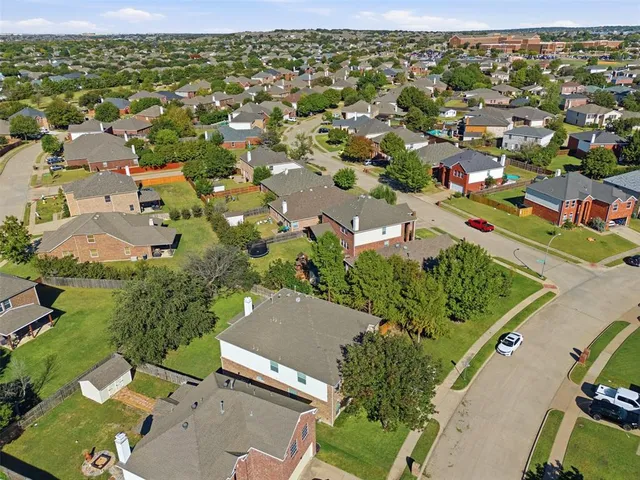 an aerial view of residential houses with outdoor space
