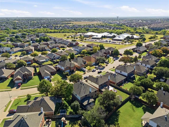 an aerial view of residential houses with outdoor space