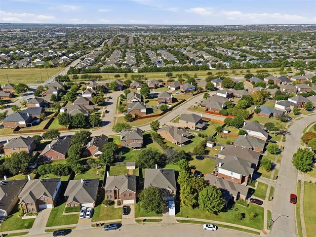 an aerial view of residential houses with outdoor space