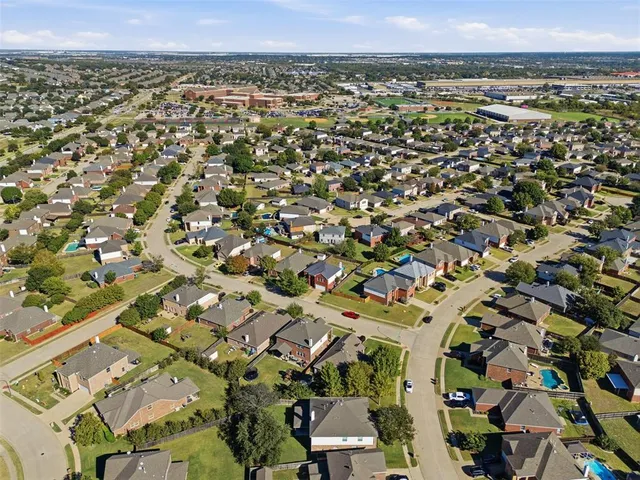 an aerial view of a residential houses with city view