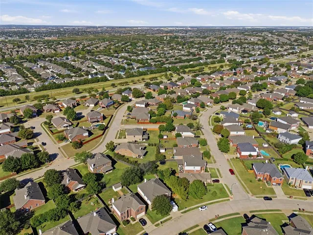 an aerial view of residential houses with outdoor space