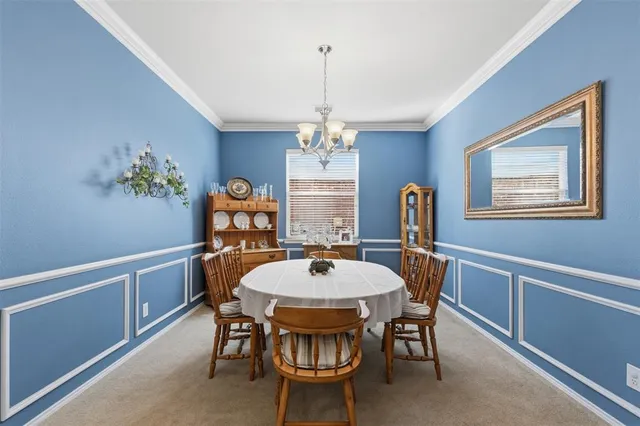 a dining room with furniture a chandelier and window