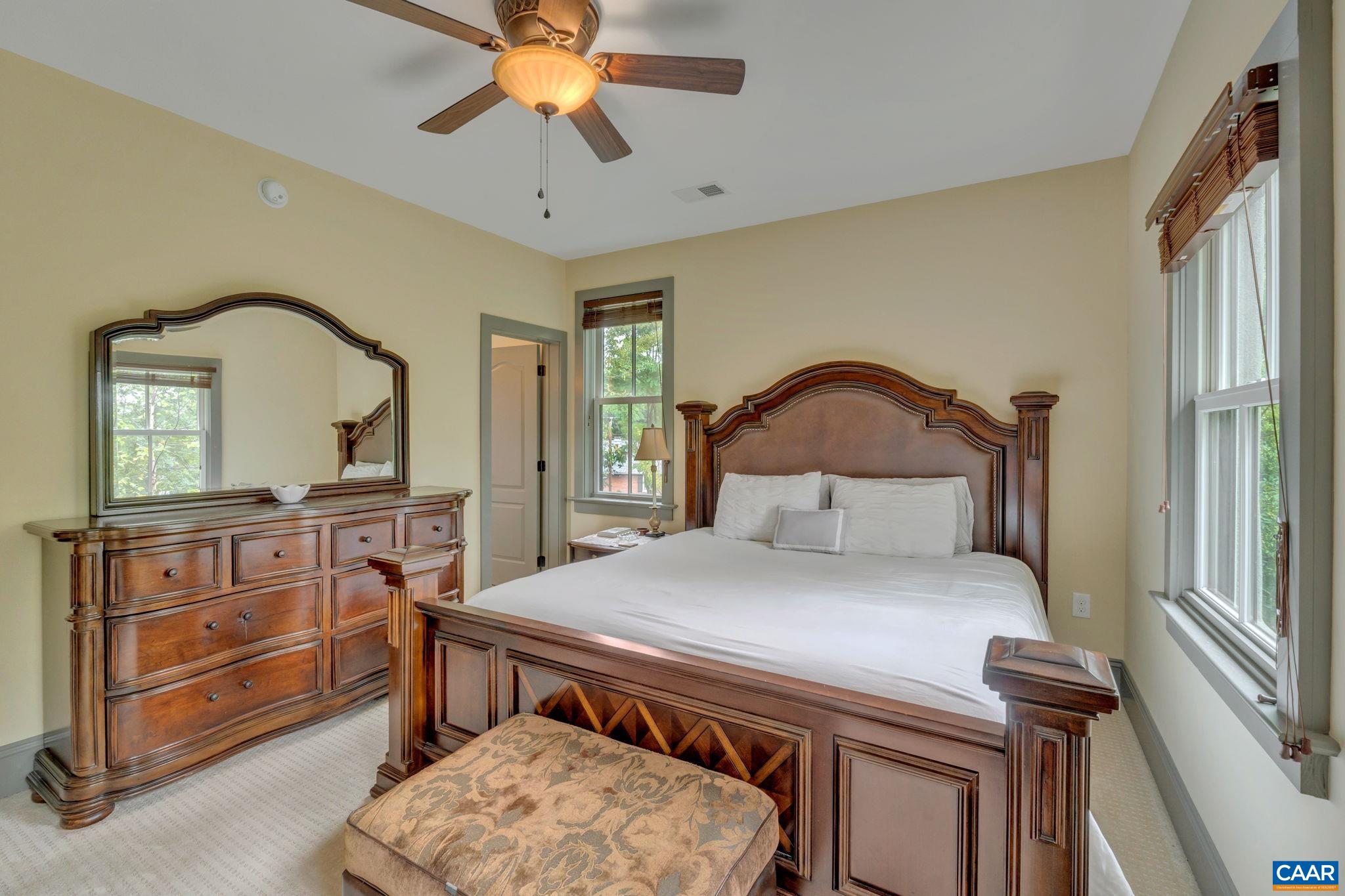 803 Rugby Road Charlottesville, VA 22903 - Photo 40 of 74 a bedroom with a bed a chandelier and dresser