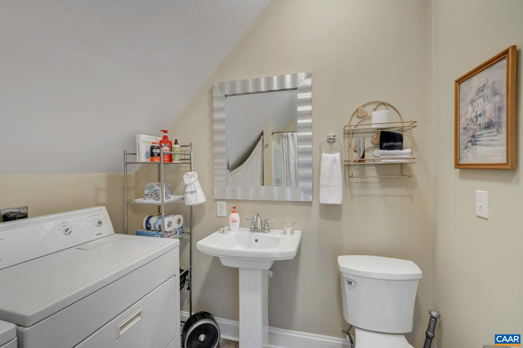 803 Rugby Road Charlottesville, VA 22903 - Photo 62 of 74 a bathroom with a toilet sink and mirror