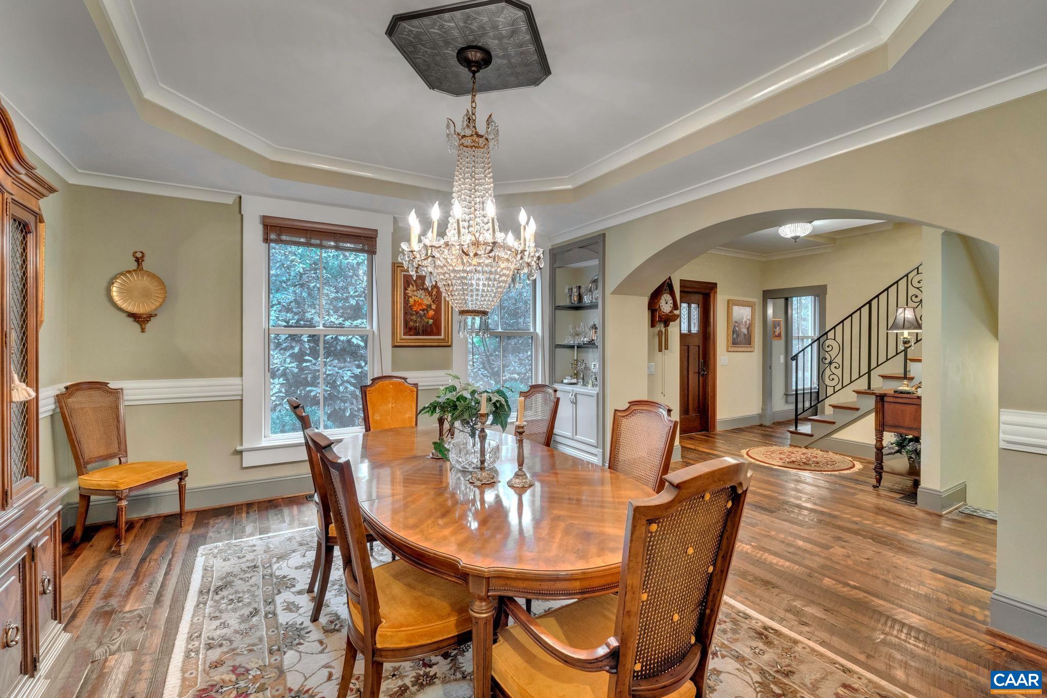 803 Rugby Road Charlottesville, VA 22903 - Photo 7 of 74 a dining room with furniture a chandelier and wooden floor