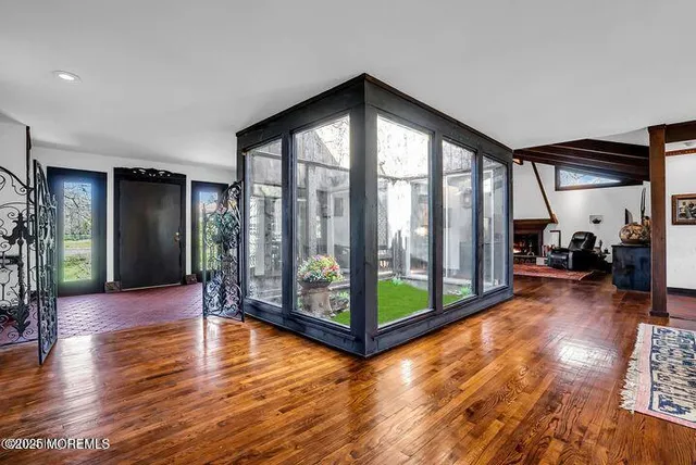 a view of a hallway with chairs and couches in a room