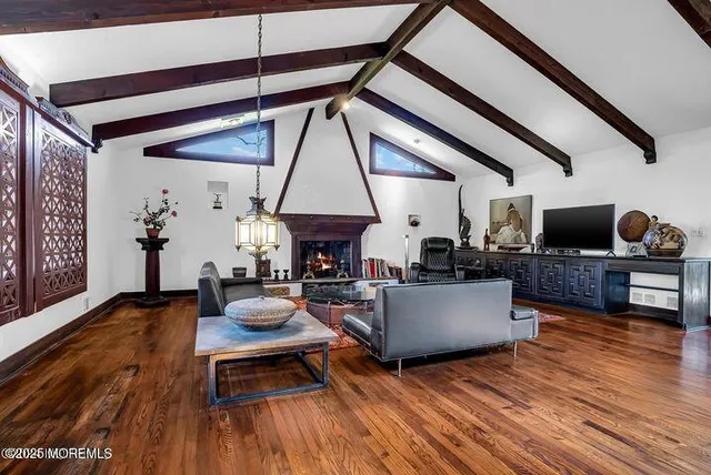 a living room with fireplace furniture and a large window