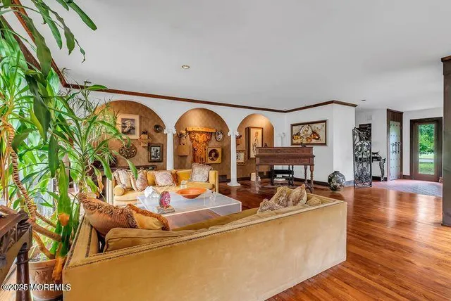a living room with fireplace furniture and a wooden floor