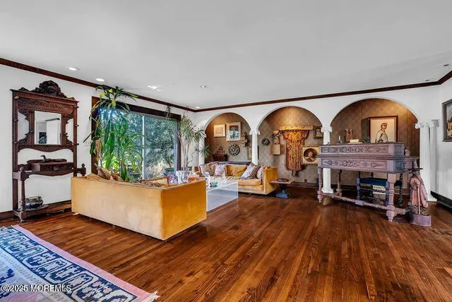 a dining room with furniture a rug a rug and a floor to ceiling window