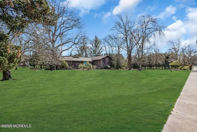 a view of house with backyard
