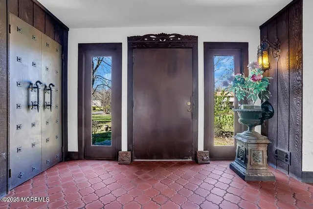 a view of an entryway with wooden floor