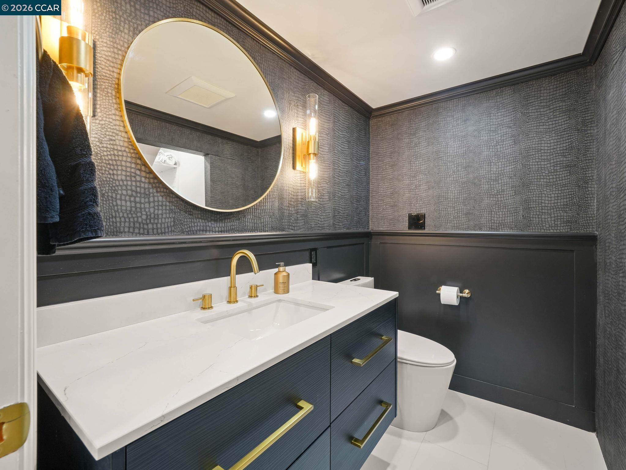 1622 San Luis Road Walnut Creek, CA 94597 - Photo 7 of 29 a bathroom with a toilet sink and mirror