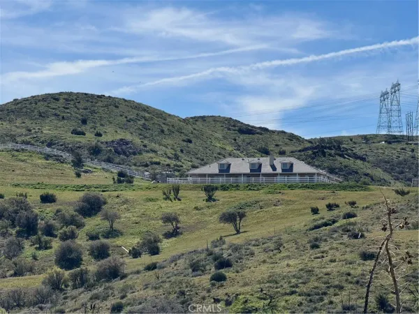 a view of a field with mountains in the background