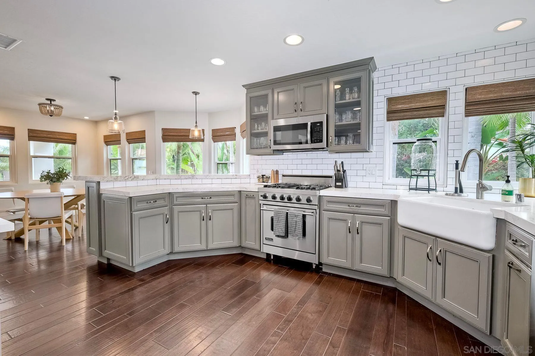 1408 Caudor Street Encinitas, CA 92024 - Photo 18 of 75 a kitchen with stainless steel appliances kitchen island granite countertop a stove a sink and white cabinets with wooden floor