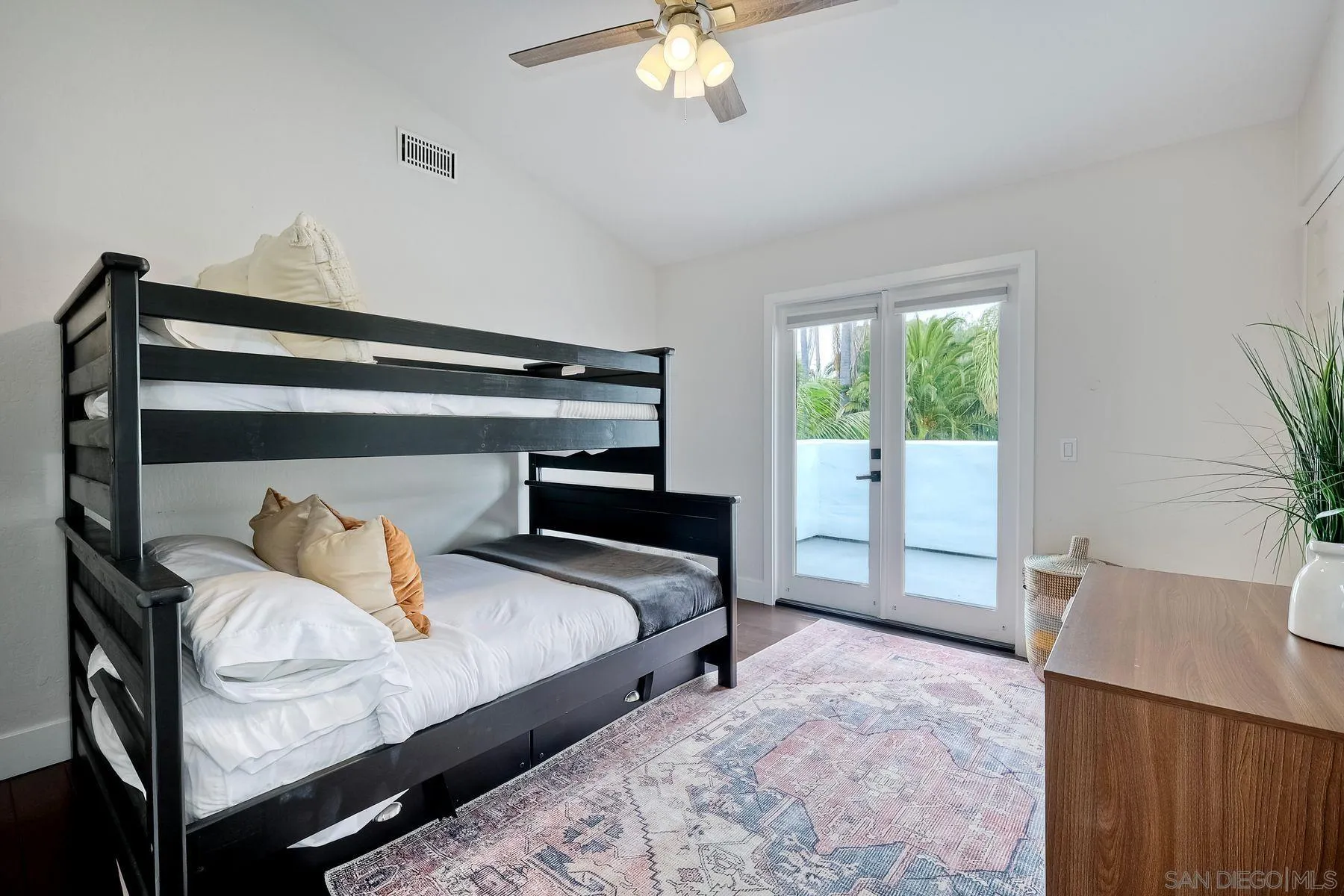 1408 Caudor Street Encinitas, CA 92024 - Photo 25 of 75 a bedroom with a bed and a chandelier