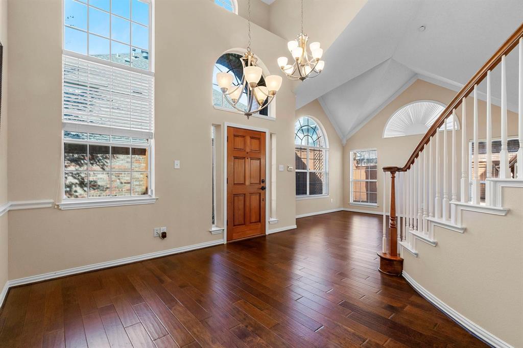 14588 Poe Court Addison, TX 75001 - Photo 7 of 28 a view of a livingroom with wooden floor and stairs