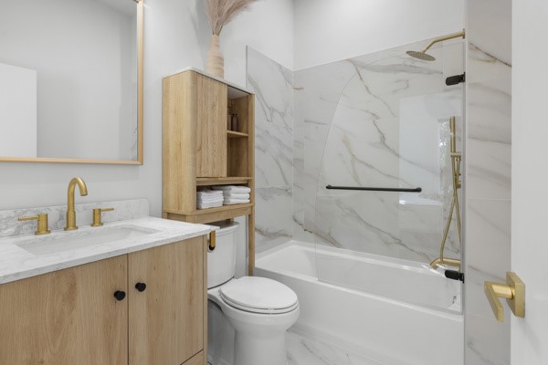 516 Hillandale Road Seneca, SC 29672 - Photo 23 of 50 This bathroom features elegant gold-toned fixtures and classic marble-patterned tile, enhancing the clean aesthetic.