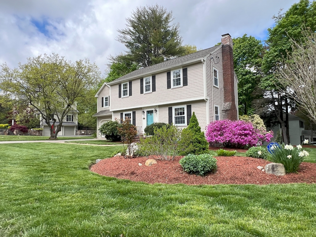 85 Blake Road Lexington, MA 02420 - Photo 1 of 42 a front view of a house with a garden and trees