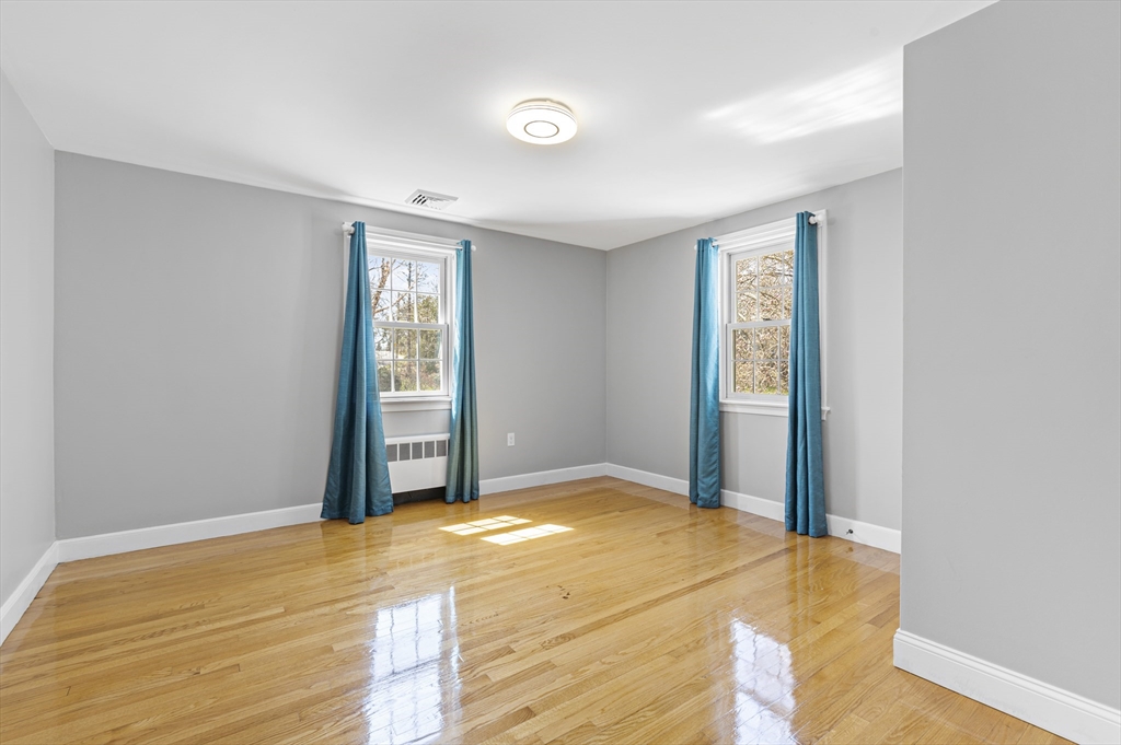 85 Blake Road Lexington, MA 02420 - Photo 27 of 42 a bedroom with a bed and a window
