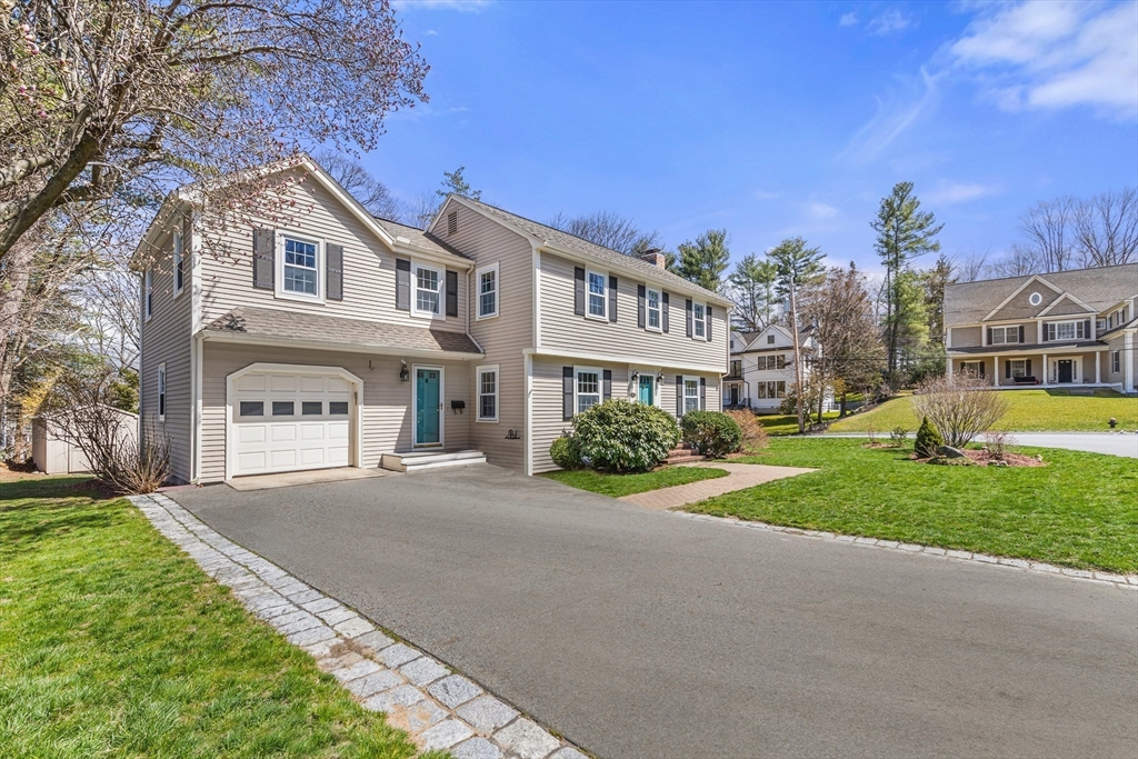 85 Blake Road Lexington, MA 02420 - Photo 3 of 42 a front view of a house with a yard and garage