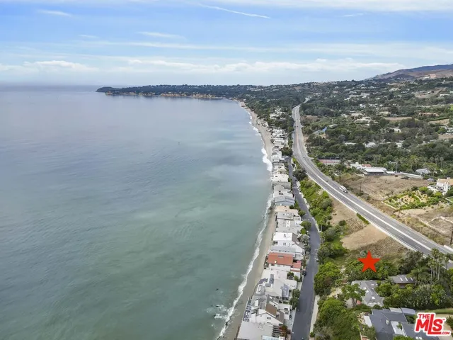 an aerial view of a city with mountains