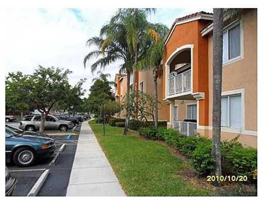 3874 Lyons Road, Unit 3026 Coconut Creek, FL 33073 - Photo 2 of 5 a view of a front door of house with fire pit