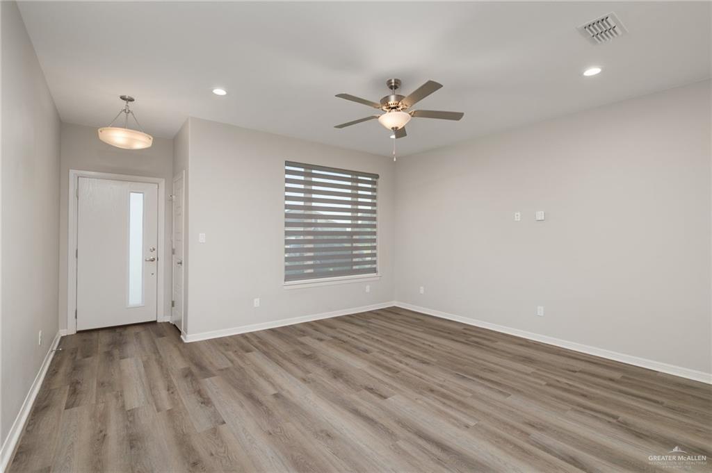 14325 Chalk Rdg Drive McAllen, TX 78504 - Photo 2 of 17 a view of empty room with wooden floor and fan