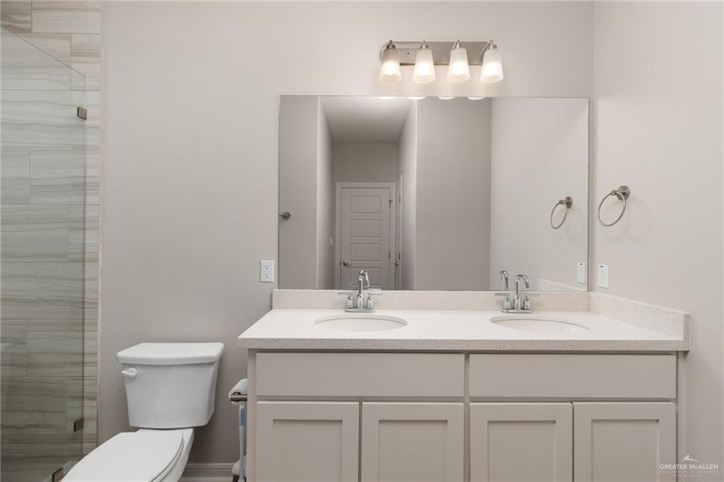 14325 Chalk Rdg Drive McAllen, TX 78504 - Photo 6 of 17 a bathroom with a sink toilet and a mirror