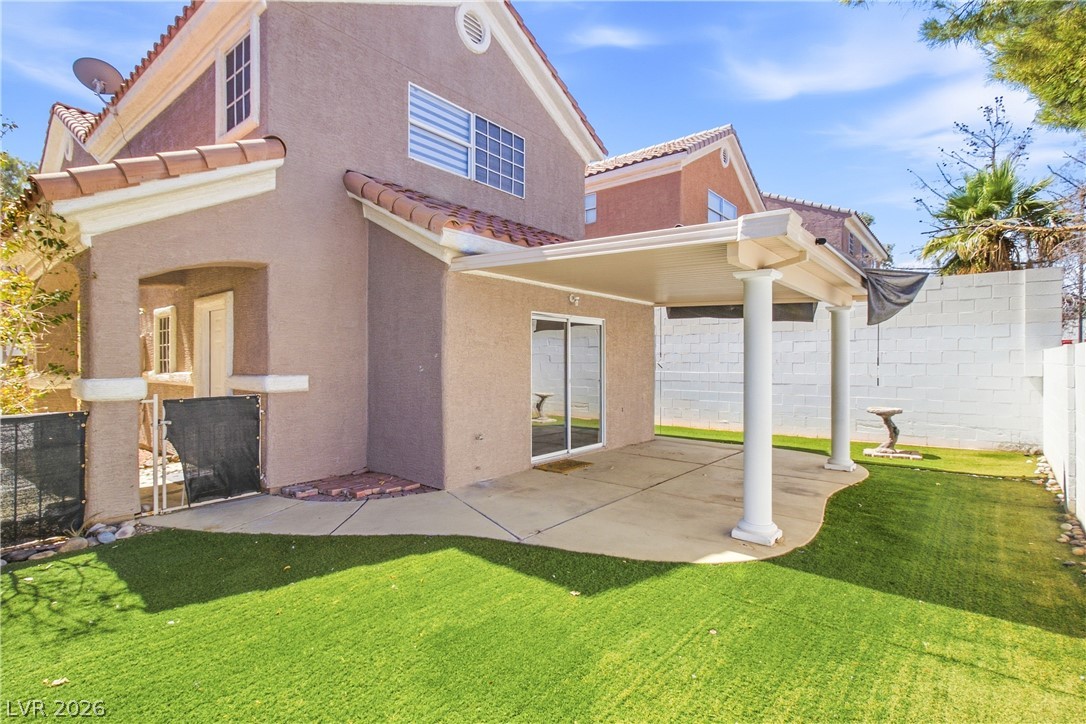 1475 Reef Ridge Court Las Vegas, NV 89128 - Photo 18 of 24 A spacious covered patio overlooks the private backyard with low-maintenance turf.